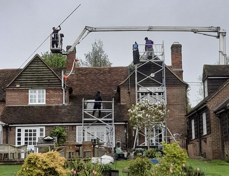 The Roof Moss Cleaners using cherry picker and scaffolding to clean roof safely and professionally in Nuneaton, Warwickshire